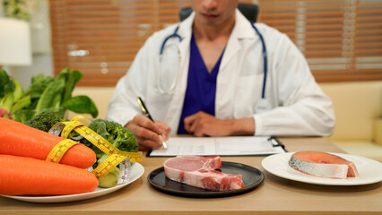 professional nutritionist in uniform writing notes on the table with different healthy products and drawings on the topic of healthy eating