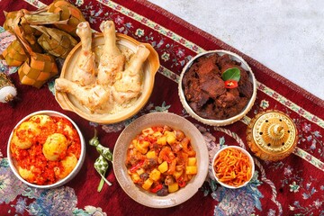 Ketupat Lebaran atau Eid Ketupat. The dishes served during Eid al-Fitr and Eid al-Adha are Ketupat, Opor Ayam, Rendang, Telur Balado, Sayur Labu Siam, and Sambal Goreng Hati. Selective Focus .