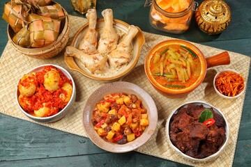 Ketupat Lebaran atau Eid Ketupat. The dishes served during Eid al-Fitr and Eid al-Adha are Ketupat, Opor Ayam, Rendang, Telur Balado, Sayur Labu Siam, and Sambal Goreng Hati. Selective Focus .