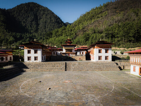 Aerial view of the Lhakhang Karpo monastery, its white walls stark against the backdrop of verdant hills, a serene tableau of Bhutanese architecture., Ha, Haa, Bhutan.