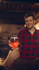 Man offering beer glass to friend across bar counter with warm lighting. Concept of social drinking culture, bar promotions, beverage marketing, nightlife visuals.