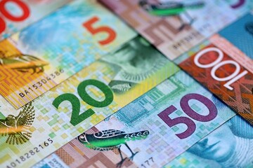 New Zealand dollar money bills in big amount on table close up. Rich life concept in New Zealand. Business and economy