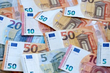 Euro money bills banknotes in big amount on table close up. Huge quantity of European Union currency cash on smooth surface. Business and rich life concept
