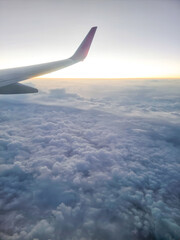 Obraz premium View from the window of an airplane wing high above the ground.