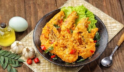 Udang Telur Asin. Salted Egg Prawns is a simple dish made from prawns, salted eggs and curry leaves.