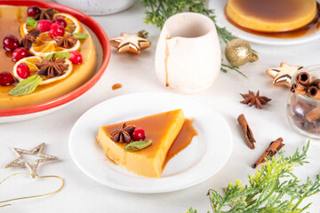 Traditional Mexican Christmas food  - caramel Eggnog Flan cake, Festive Christmas Custard Tart or Flan Topped with Caramel sauce, candied orange and cranberry, with Christmas decor copy space