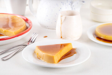 Traditional flan cake, Custard Tart or Flan Topped with Caramel sauce on white kitchen table copy space