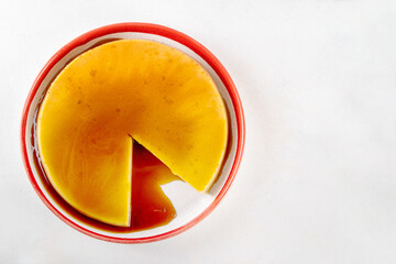 Traditional flan cake, Custard Tart or Flan Topped with Caramel sauce on white kitchen table copy space