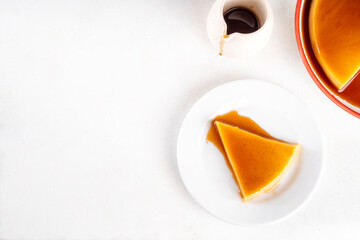 Traditional flan cake, Custard Tart or Flan Topped with Caramel sauce on white kitchen table copy space