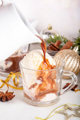 Affogato hot chocolate, on Christmas decorated background. Tasty hot chocolate or cocoa drink with vanilla ice cream scoops, copy space