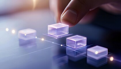 A close-up shot of a person's hand placing a glowing transparent cube onto a digital interface. The background is dark with soft bokeh lights.