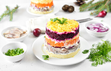Layered salad with beet, herring, carrots and potatoes