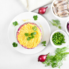 Layered salad with beet, herring, carrots and potatoes