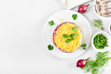 Layered salad with beet, herring, carrots and potatoes