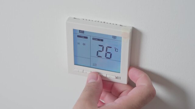 Adjust temperature at remote control with display for using air conditioner, close up. High quality 4k footage