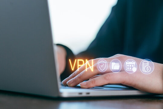 Using a laptop to secure online privacy with a VPN service at a modern workspace during the daytime