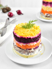 Layered salad with beet, herring, carrots and potatoes