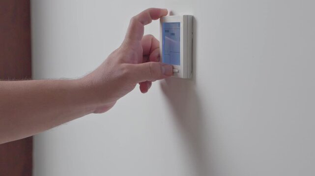 Adjust temperature at remote control with display for using air conditioner, close up. High quality 4k footage