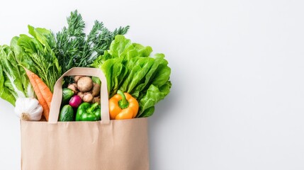 Paper bag filled with fresh organic vegetables on white background with copy space. Eco friendly shopping, healthy food choices and natural produce for sustainable lifestyle