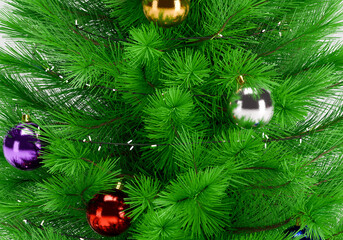 Close up of a perfectly decorated Christmas tree with balls on a white background