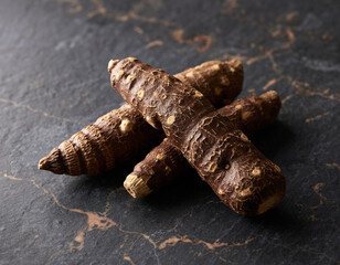 Obraz premium Closeup of Raw Arrowroot Tubers on a Textured Dark Surface, Healthy Ingredient, Macro Photography
