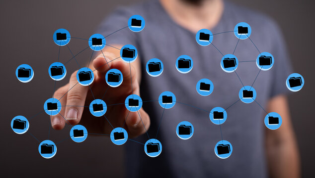 Close-up of a hand interacting with a network of digital files, highlighting cloud storage and data connection.