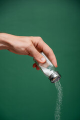 Hand Seasoning Food with Fine White Salt