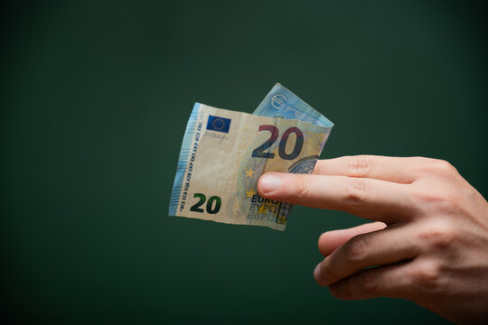 Hand holding twenty euro banknote cash payment
