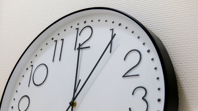 Classic White Faced Wall Clock Keeping Time