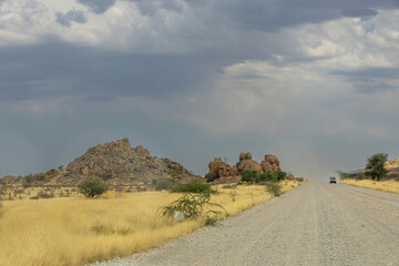 Car Driving on Gravel Road in Namibia&rsquo;s Hardap Region, Raising Dust