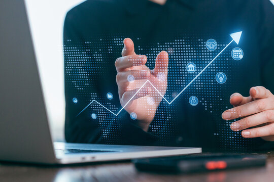 Business professional analyzes growth trends with digital charts during work hours - Powered by Adobe