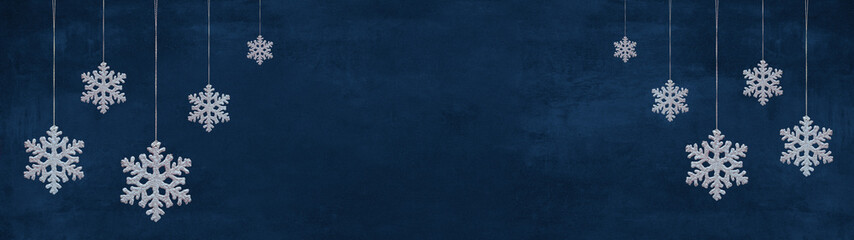 Christmas celebration holiday banner template greeting card panorama, with text - Group of hanging white snowflakes, ice crystals ornaments, isolated on blue background