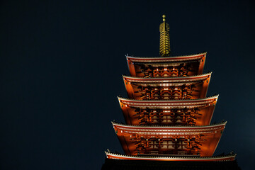 Illuminated Japanese pagoda tower at night