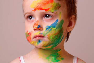 An innocent smile transformed into a living rainbow.