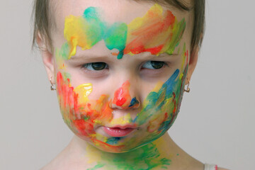 A joyful little artist celebrating creativity with a colorful smile.