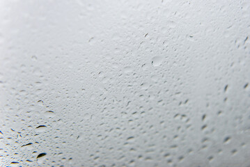 Water Droplets on Foggy Glass Surface Creating Soft Abstract Texture