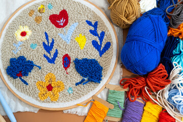 Colorful yarn and floral design in a crafting session on a sunny afternoon at home