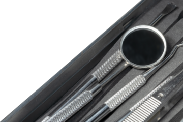 dental instruments on blue background. Dental treatment. Dentist tools mirror, hook. 