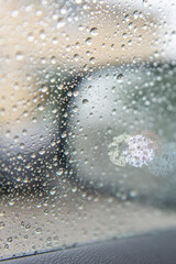 Raindrops on Car Window with Soft Colorful Bokeh Background