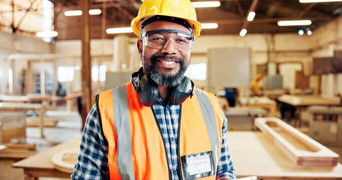Carpentry, happy and portrait of black man in workshop for furniture repair, building and woodworking. Carpenter, safety gear and mature person smile in factory for wood, lumber and timber production - Powered by Adobe