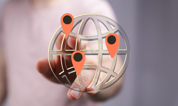 Hand interacting with a digital globe showing multiple location pins. Represents global reach, connectivity, and worldwide business.