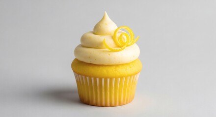 Delicious lemon cupcake with creamy yellow frosting and elegant lemon zest curl on a light background