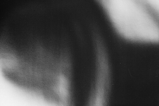 retro film overlay effect with scratch dust and light leaks,retro grain noisy film distressed texture light leak flare on black background,dark grunge background,old film analog background
