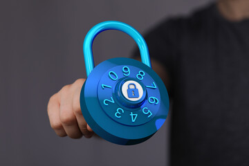 Image of a person's hand holding a blue digital padlock, symbolizing online security, privacy, and...