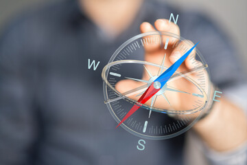 Close up shot of a hand holding a glowing compass, concept of direction, navigation, and guidance...