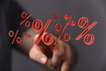 Hand pointing at floating red percentage symbols. Concept for discounts, sales, financial growth,...