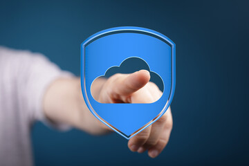 Secure cloud data concept with hand touching cloud in shield, representing safe online storage. Data protection