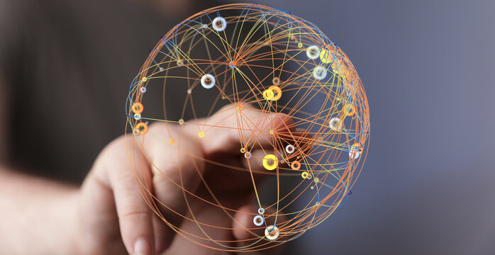 Hand reaching towards a glowing sphere representing global network and technology connections. Abstract digital concept of innovation