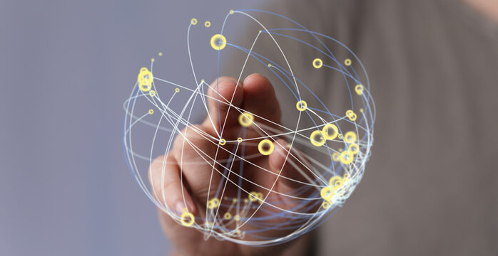 Hand reaching towards a digital sphere representing global connection, network, and communication. Concept of internet, globalization
