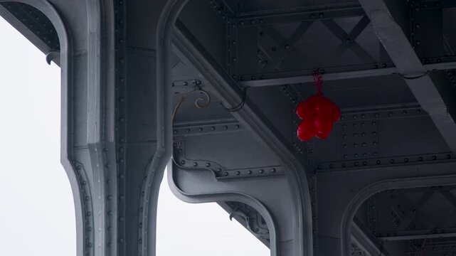 Enigmatic view of a Red Balloon in the steel environment of the Bir Hakeim bridge